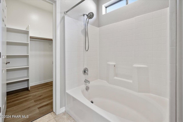 bathroom featuring shower / bathing tub combination and hardwood / wood-style flooring