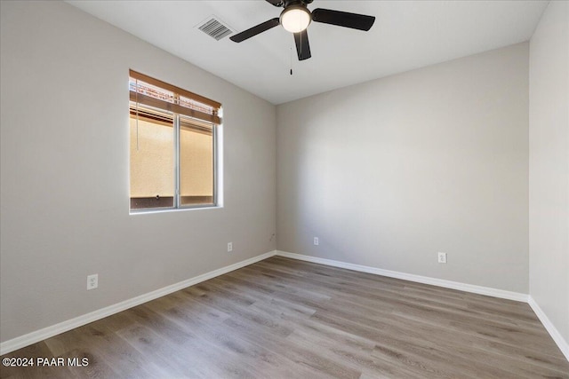 empty room with ceiling fan and hardwood / wood-style floors