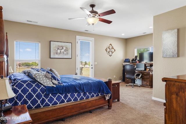 bedroom featuring ceiling fan, access to exterior, light carpet, and multiple windows