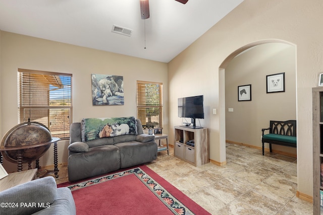 living room featuring ceiling fan and vaulted ceiling