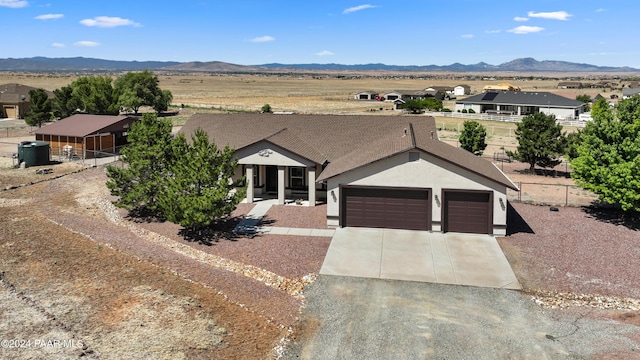 ranch-style house with a mountain view and a garage