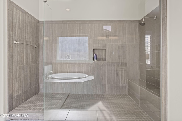 bathroom featuring shower with separate bathtub