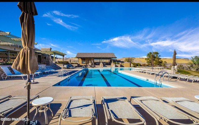 view of swimming pool with a patio