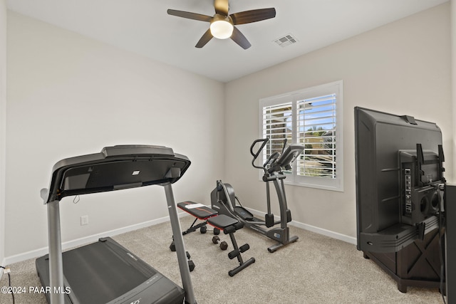 exercise area with light carpet and ceiling fan