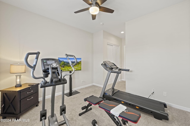 exercise area with ceiling fan and light carpet