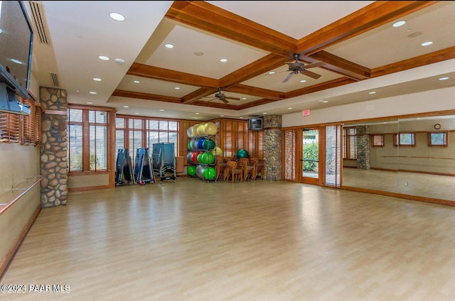 workout area with ceiling fan, light hardwood / wood-style floors, and coffered ceiling