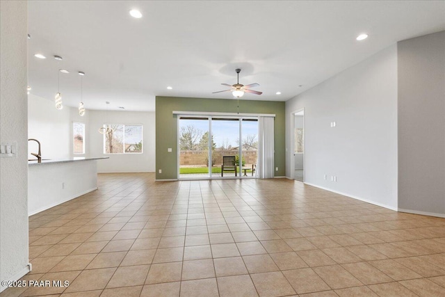 unfurnished room featuring recessed lighting, baseboards, a sink, light tile patterned flooring, and ceiling fan