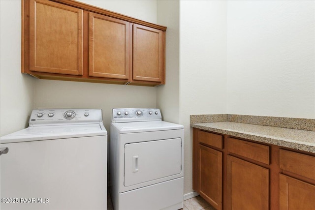 laundry area featuring cabinet space and separate washer and dryer