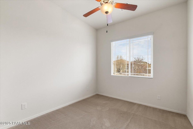 unfurnished room featuring baseboards, a ceiling fan, and light carpet