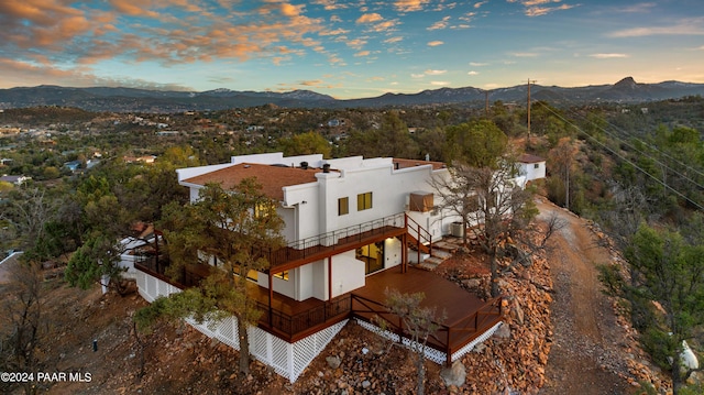 aerial view at dusk featuring a mountain view