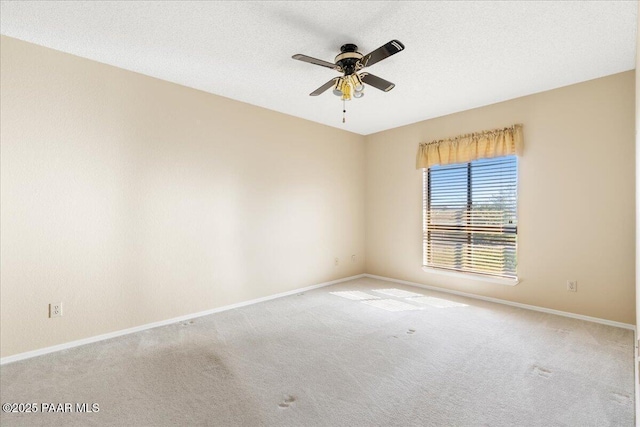 carpeted empty room with baseboards, a textured ceiling, and ceiling fan