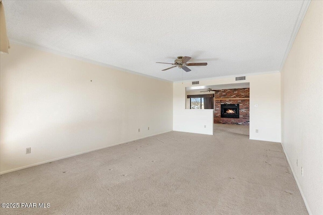 unfurnished living room with crown molding, a fireplace, visible vents, and a textured ceiling