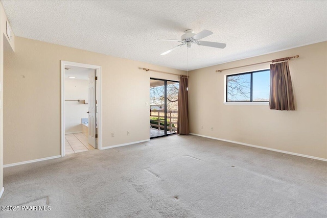 unfurnished bedroom with access to outside, a textured ceiling, ensuite bath, carpet, and baseboards