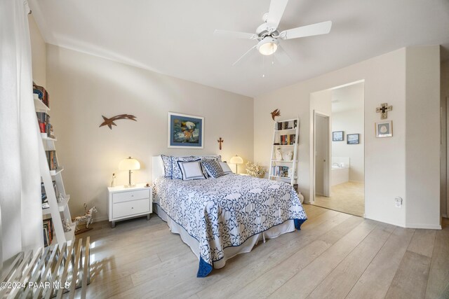 bedroom featuring ensuite bath, ceiling fan, and light hardwood / wood-style floors