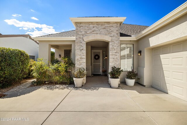 doorway to property with a garage