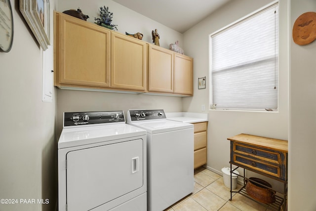 laundry area featuring light tile patterned flooring, cabinets, and independent washer and dryer