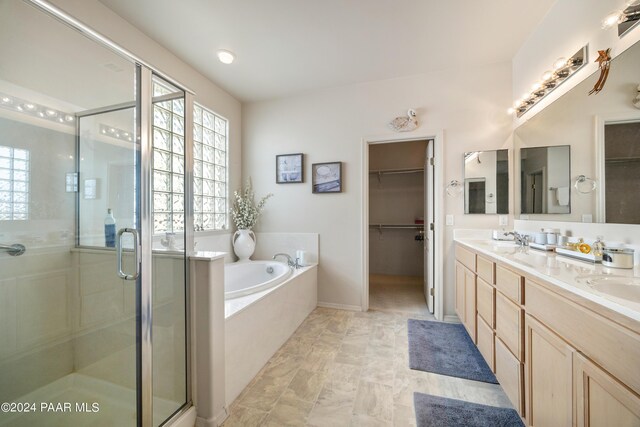 bathroom featuring plus walk in shower and vanity