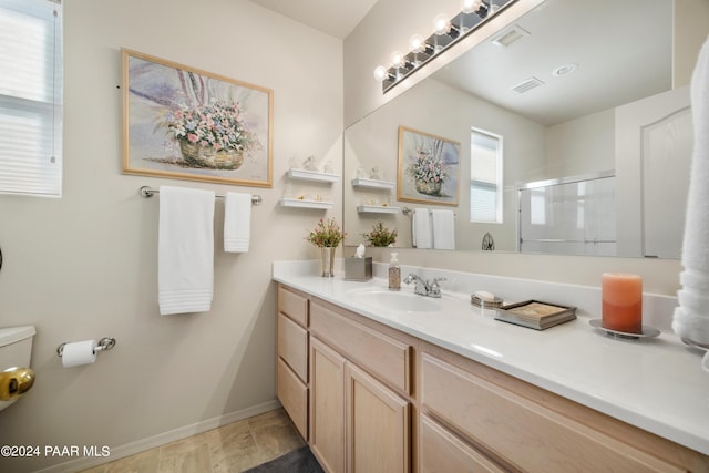 bathroom featuring vanity and an enclosed shower