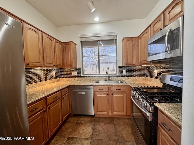 7218 E Night Watch Way, Prescott Valley, AZ 86314 - kitchen featuring a sink, appliances with stainless steel finishes, tasteful backsplash, and light stone counters