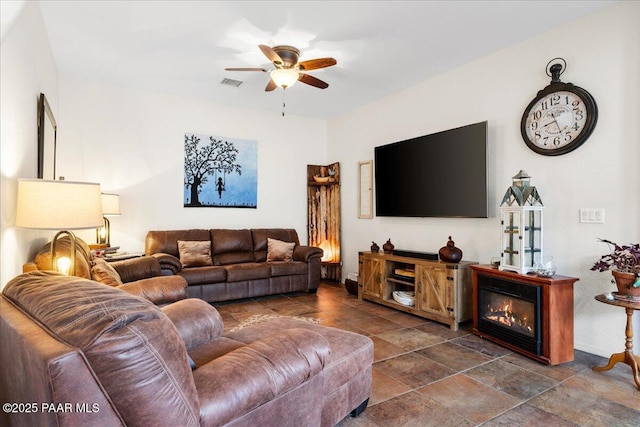 living room with visible vents and a ceiling fan