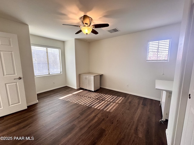 7218 E Night Watch Way, Prescott Valley, AZ 86314 - unfurnished bedroom with dark wood-type flooring, baseboards, visible vents, and multiple windows