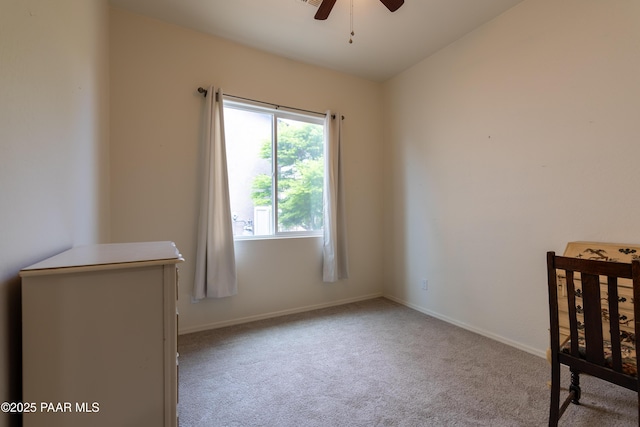 unfurnished bedroom with baseboards, a ceiling fan, and carpet