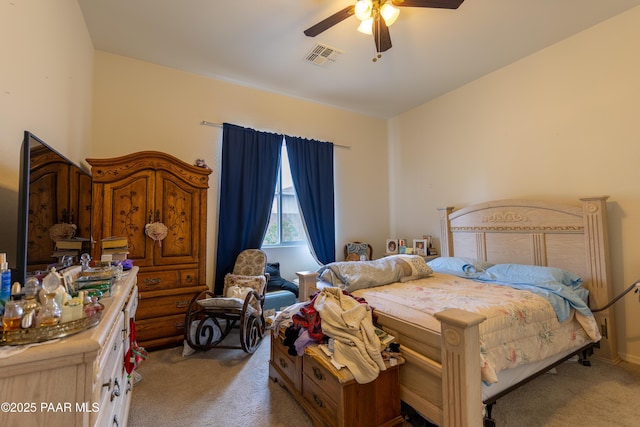 bedroom featuring visible vents, ceiling fan, and light colored carpet