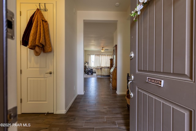 entrance foyer featuring dark wood-style flooring, ceiling fan, and baseboards