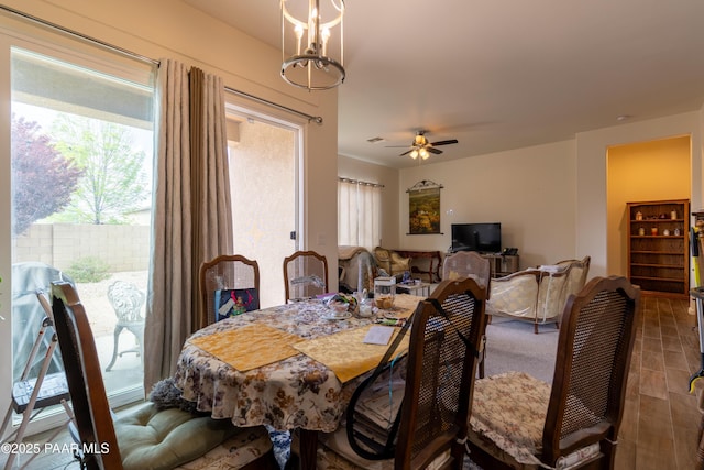 dining area with wood finished floors and a ceiling fan