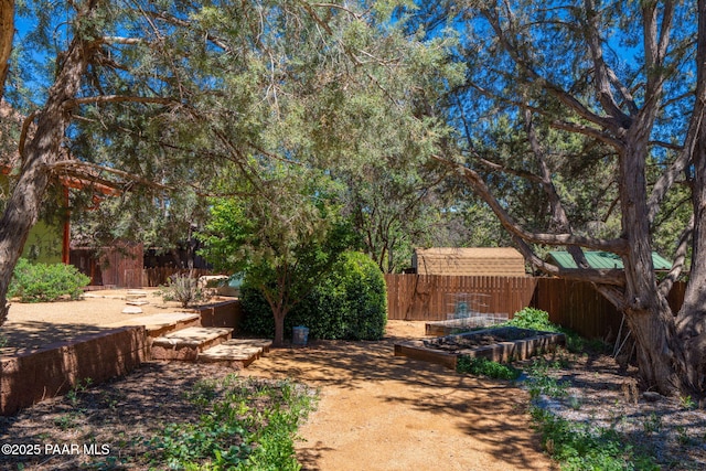 fenced backyard with a garden