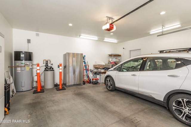 garage with water heater, a garage door opener, and recessed lighting