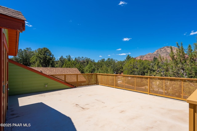 view of patio with a forest view and a mountain view