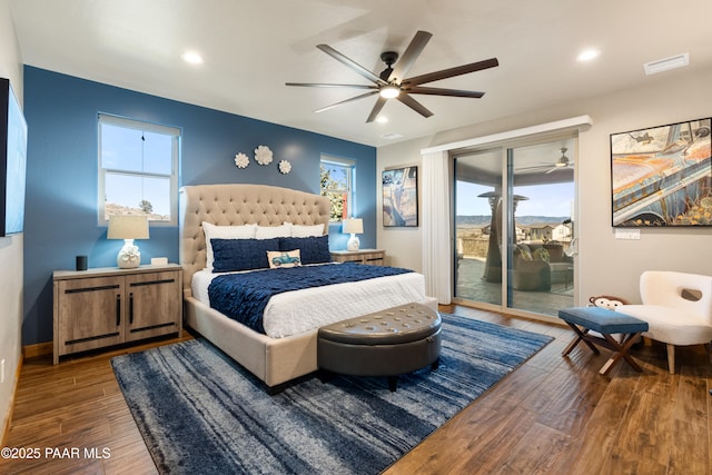 bedroom featuring dark hardwood / wood-style flooring, access to outside, and ceiling fan