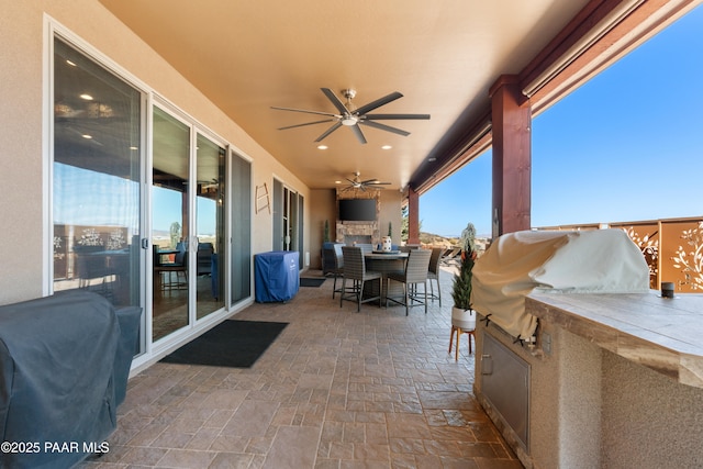 view of patio featuring a bar, area for grilling, and ceiling fan