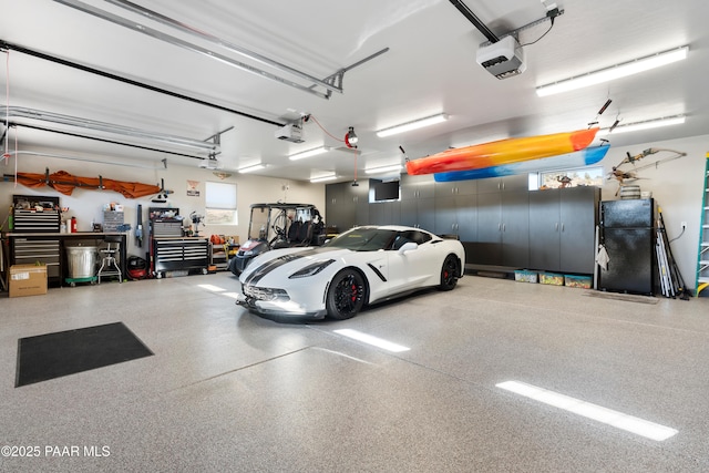 garage with a garage door opener and a workshop area