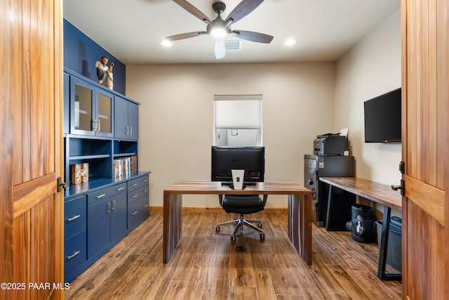 office with hardwood / wood-style flooring and ceiling fan