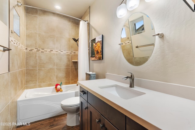 full bathroom with vanity, wood-type flooring, shower / tub combo, and toilet