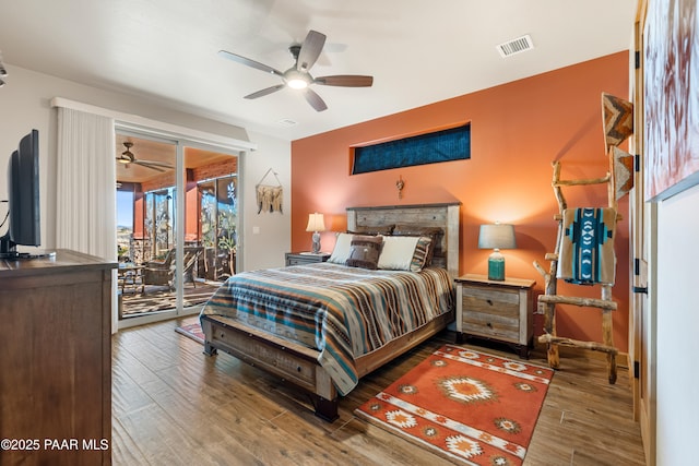 bedroom with ceiling fan, wood-type flooring, and access to exterior