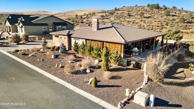 view of front of home with a patio and a mountain view