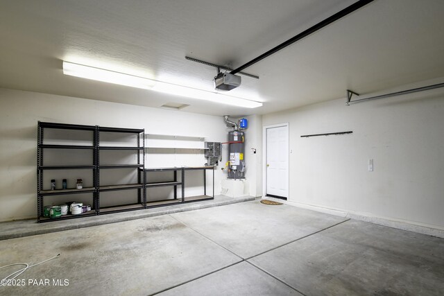 garage featuring gas water heater and a garage door opener