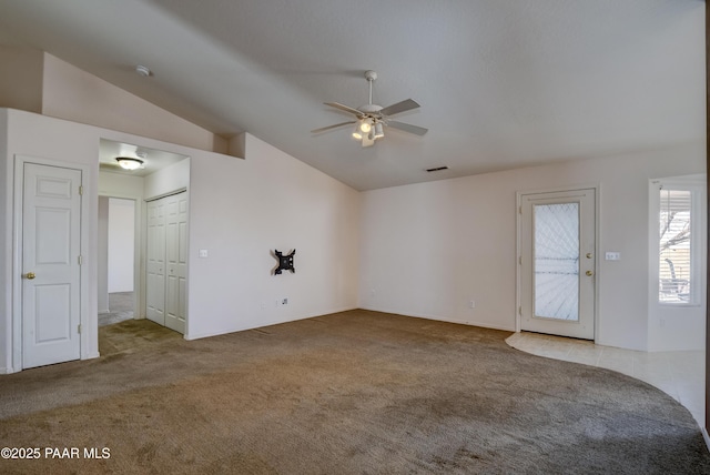 carpeted empty room with visible vents, ceiling fan, and lofted ceiling