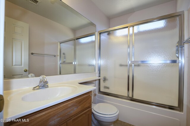 full bathroom featuring combined bath / shower with glass door, visible vents, toilet, and vanity