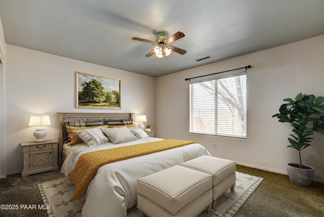 carpeted bedroom featuring visible vents, baseboards, and a ceiling fan