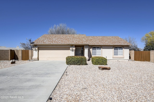 ranch-style home featuring fence, driveway, a shingled roof, stucco siding, and a garage