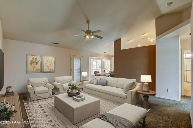 carpeted living room with vaulted ceiling, a ceiling fan, and visible vents