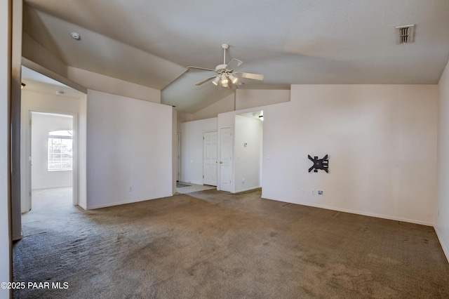 carpeted empty room with visible vents, baseboards, a ceiling fan, and vaulted ceiling