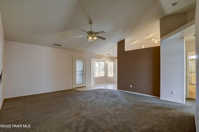 empty room featuring lofted ceiling, carpet flooring, a ceiling fan, and visible vents