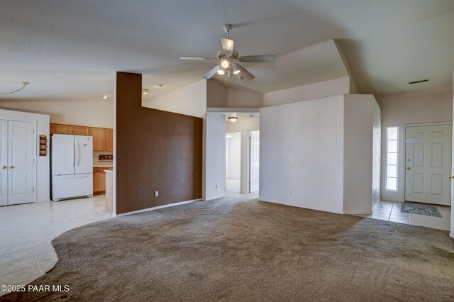 unfurnished living room featuring light tile patterned floors, light colored carpet, high vaulted ceiling, and a ceiling fan