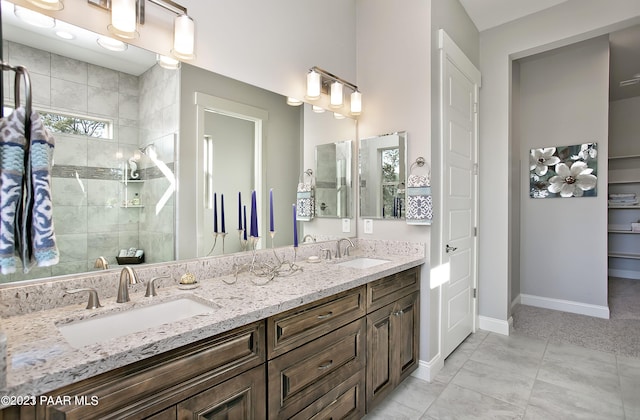12345 N Petra Cir, Prescott, AZ 86305 - full bathroom with double vanity, a tile shower, baseboards, and tile patterned flooring