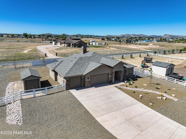 birds eye view of property with a mountain view and a rural view